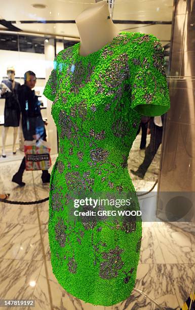 Designer garment created from food titled 'Neon Italia', a calico dress with a risoni pasta crust, glazed with neon green paint and garnished with...