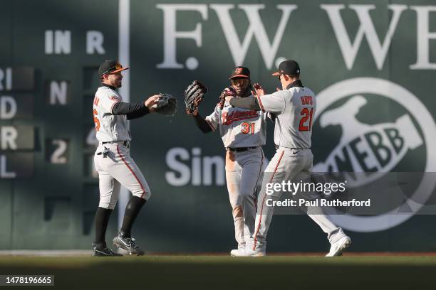 Austin Hays and Ryan McKenna and Cedric Mullins of the Baltimore Orioles celebrate after defeating the Boston Red Sox on Opening Day at Fenway Park...