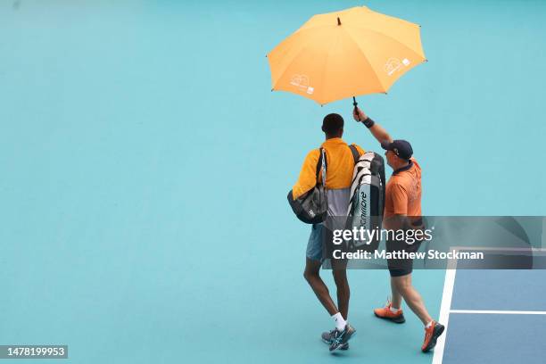 Christopher Eubanks of the United States walks of the court as rain suspends play against Daniil Medvedev of Russia after their match during the...