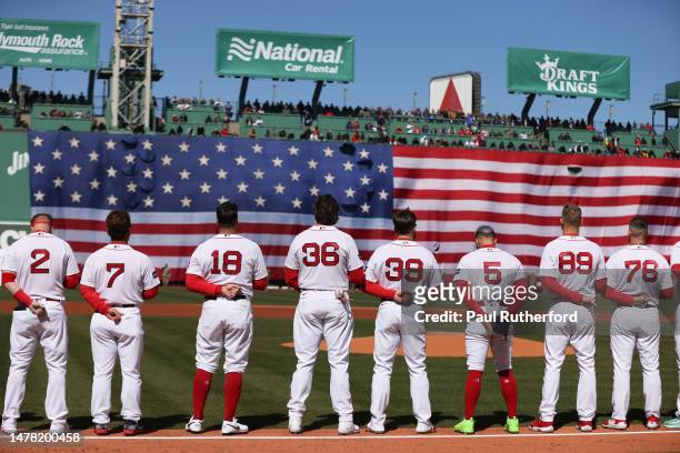 Members of the Boston Red Sox stand on the first base line on Opening Day at Fenway Park on March 30, 2023 in Boston, Massachusetts.