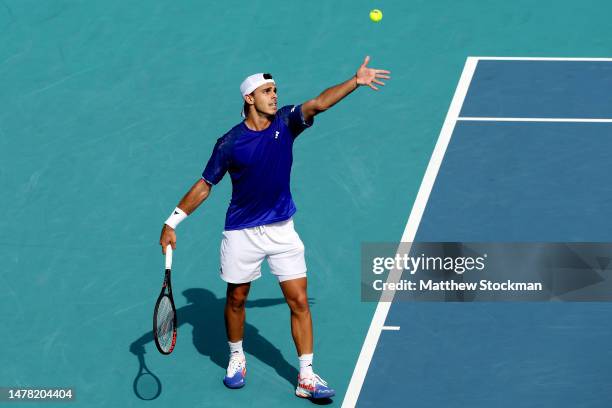 Francisco Cerundolo of Argentina serves to Karen Khachanov of Russia during the quarterfinals of the Miami Open at Hard Rock Stadium on March 30,...