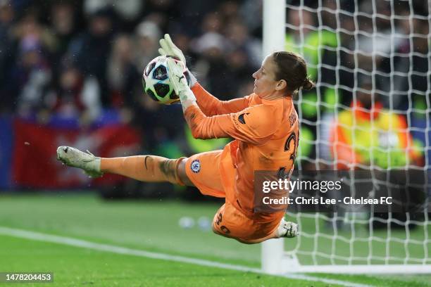 Ann-Katrin Berger of Chelsea makes a save from Wendie Renard of Olympique Lyonnais for Olympique Lyonnais' third penalty in the shootout during the...