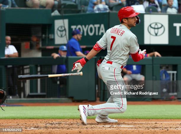Trea Turner of the Philadelphia Phillies hits a triple in the third inning against the Texas Rangers on Opening Day at Globe Life Field on March 30,...