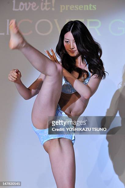 Twenty-year-old model Kaede Aono gives a karate kick performance in a swimsuit at the 10th Rayli cover girl contest in Tokyo on July 4, 2012. Aono...