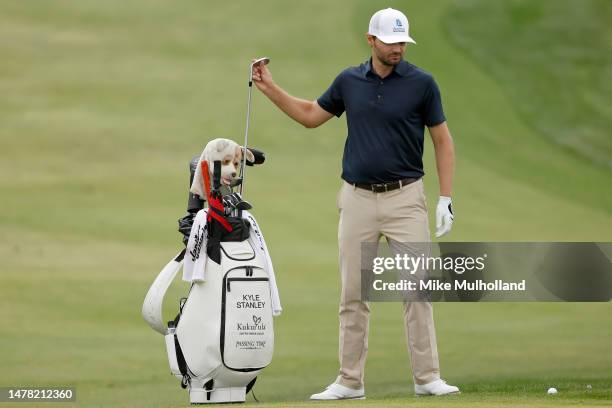 Kyle Stanley of the United States selects a club from his bag on the eighth green during the first round of the Valero Texas Open at TPC San Antonio...
