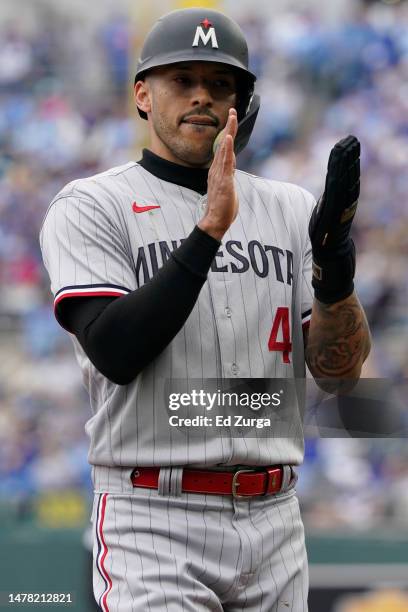 Carlos Correa of the Minnesota Twins claps as he makes his way to third in the first inning against the Kansas City Royals on Opening Day at Kauffman...