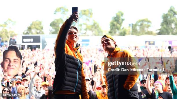 Oscar Piastri of Australia and McLaren and Lando Norris of Great Britain and McLaren talk with the crowd on the fan stage prior to practice ahead of...