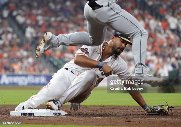 Jose Abreu of the Houston Astros beats Romy Gonzalez of the Chicago White Sox to the bag in the third inning on Opening Day at Minute Maid Park on...