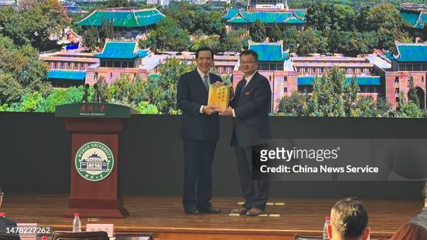 Wuhan University President Zhang Pingwen sends a book to former chairman of the Chinese Kuomintang party Ma Ying-jeou at Wuhan University on March...