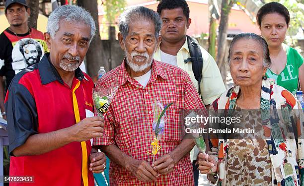 Mr Mari Alkatiri campaigns for Fretalin by handing out flowers to voters as a sign of goodwill and peace, ahead of the election on July 04, 2012 in...