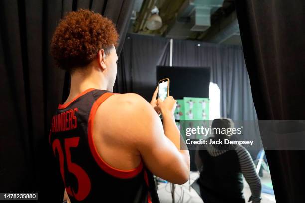 Elijah Saunders of the San Diego State Aztecs takes photos with his phone during media availability for the Final Four as part of the NCAA Men's...