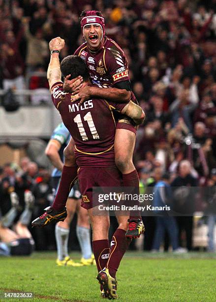 Johnathan Thurston and Nate Myles of the Maroons celebrate victory after game three of the 2012 State of Origin series between the Queensland Maroons...