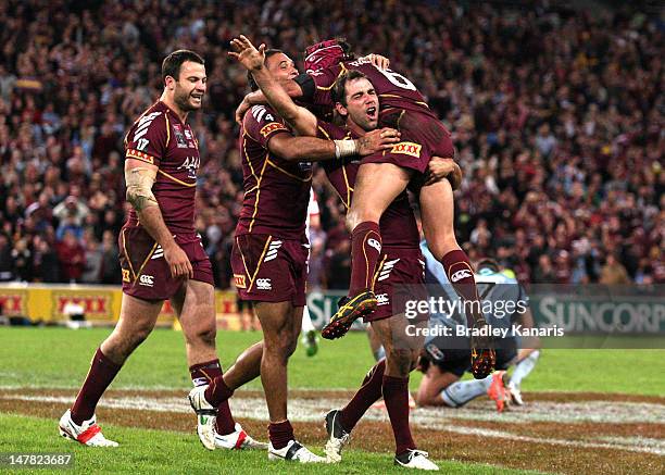 Cameron Smith, Johnathan Thurston and Justin Hodges celebrate victory after game three of the 2012 State of Origin series between the Queensland...