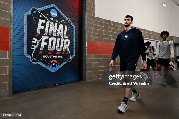 Alex Karaban of the Connecticut Huskies walks during media availability for the Final Four as part of the NCAA Men's Basketball Tournament at NRG...