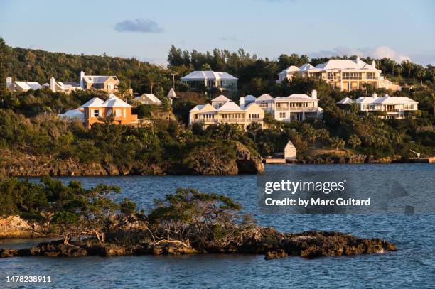 luxury homes on a hill overlooking the water, bermuda - house golden hour stock pictures, royalty-free photos & images