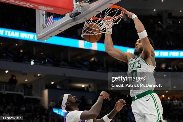 Jayson Tatum of the Boston Celtics dunks the ball against Bobby Portis of the Milwaukee Bucks in the second half at Fiserv Forum on March 30, 2023 in...