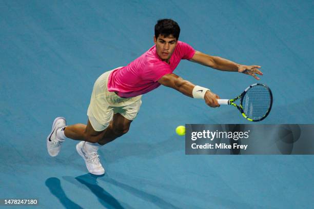 Carlos Alcaraz of Spain hits a backhand against Taylor Fritz of the United States in the quarter-finals of the men's singles at the Miami Open at the...