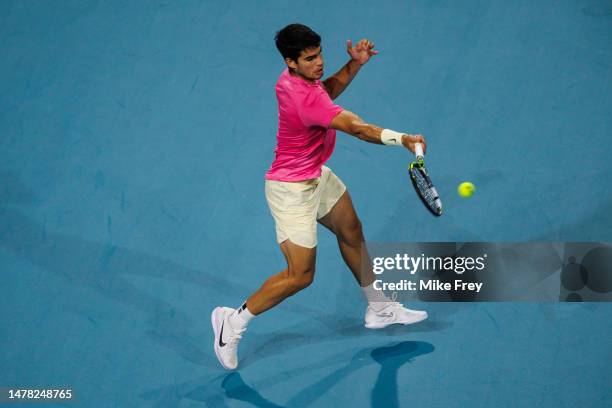 Carlos Alcaraz of Spain hits a forehand against Taylor Fritz of the United States in the quarter-finals of the men's singles at the Miami Open at the...