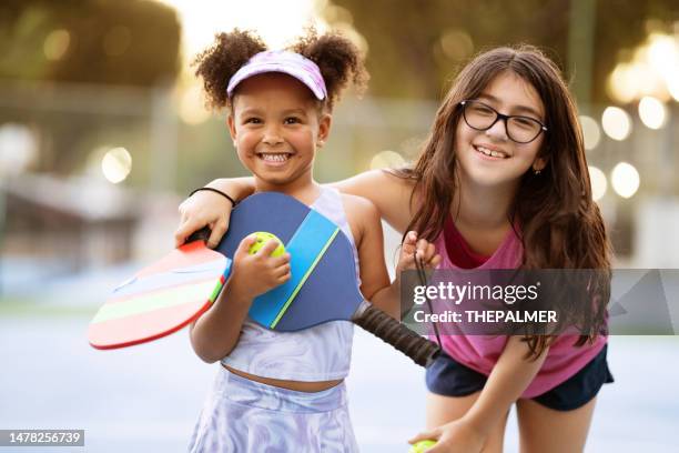 girls playing pickle ballposing for the camera - racket stock pictures, royalty-free photos & images
