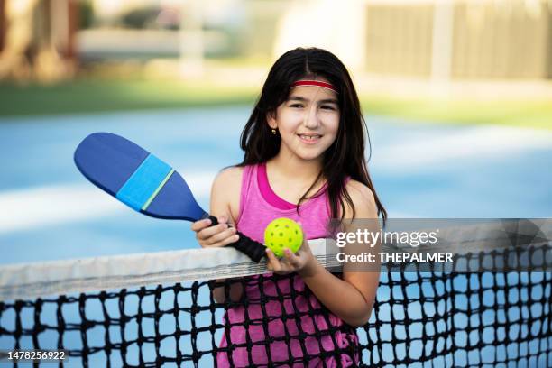 nine years old latin girl resting after pickle ball game - child saluting stock pictures, royalty-free photos & images