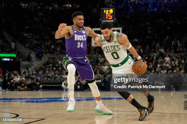 Jayson Tatum of the Boston Celtics dribbles the ball against Giannis Antetokounmpo of the Milwaukee Bucks in the second half at Fiserv Forum on March...