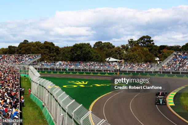 Fernando Alonso of Spain driving the Aston Martin AMR23 Mercedes leads Valtteri Bottas of Finland driving the Alfa Romeo F1 C43 Ferrari on track...