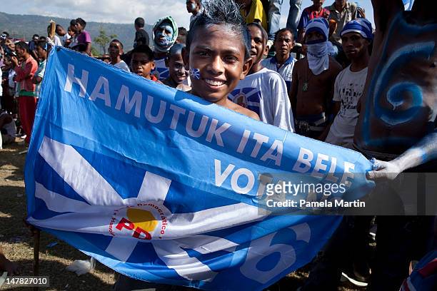 Person holds a flag durig the final Democratic Party election rally on July 04, 2012 in Dili, East Timor. Twenty-one political parties are running in...