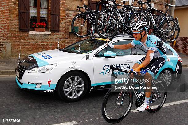 Tony Martin of Germany riding for Omega Pharma-Lotto signals the team car as he returns to the peloton during stage four of the 2012 Tour de France...