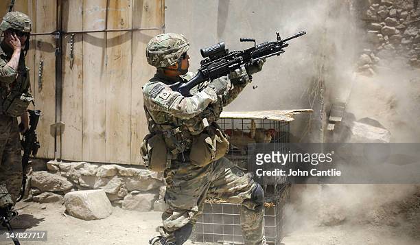 Soldiers from 2-12 Infantry Regiment out of Colorado Springs fires his gun at Taliban positions during a firefight on June 15, 2012 in the Pech...