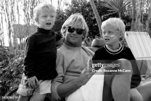 Surfer Laird Hamilton talks with kids on Old Man's beach behind the scenes on the set of a Nike Aqua Socks commercial in 1990 in San Onofre,...