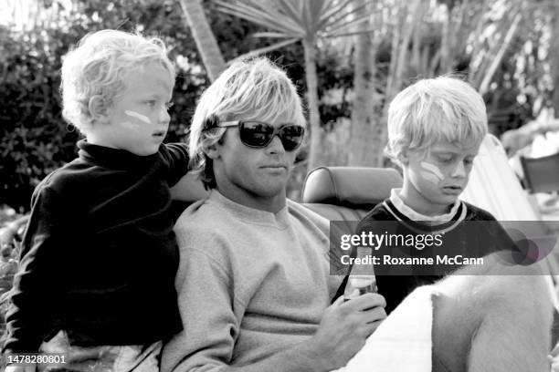 Surfer Laird Hamilton sits with kids on Old Man's beach behind the scenes on the set of a commercial for Nike Aqua Socks in 1990 in San Onofre,...