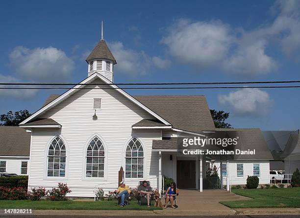 Residents in front of a church wait for the start of the Independence Day parade on July 4, 2012 in Centerville, Texas. This year marks the 236th...