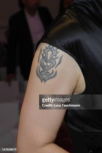 Bettina Wullf tattoo attends Basler Show during the Mercedes-Benz Fashion Week Spring/Summer 2013 at Hotel de Rome on July 4, 2012 in Berlin, Germany.