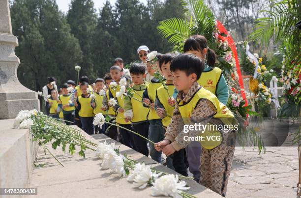 Children lay flowers to pay tribute to martyrs at a martyr cemetery before Qingming Festival, or Tomb-Sweeping Day on March 31, 2023 in Linyi,...