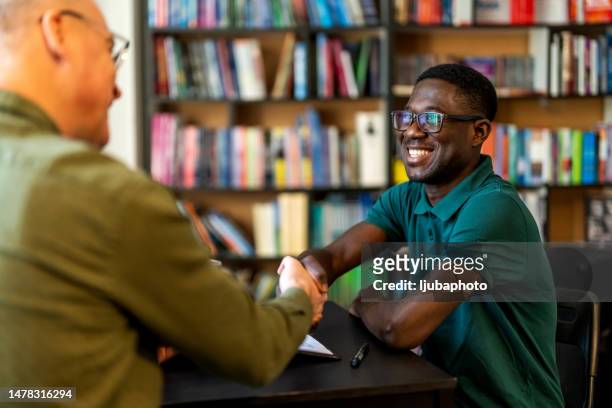 young man successful job applicant shake man hr hand - casual job interview stock pictures, royalty-free photos & images