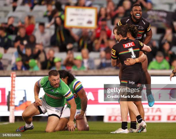 Dylan Edwards and Sunia Turuva of the Panthers celebrate with Izack Tago of the Panthers after he scored a try during the round five NRL match...