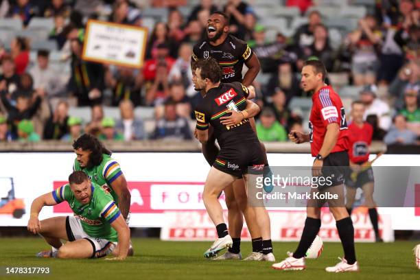 Dylan Edwards and Sunia Turuva of the Panthers celebrate with Izack Tago of the Panthers after he scored a try during the round five NRL match...