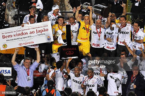 Brazil's Corinthians' capitain Alessandro holds the Libertadores Cup after winning the second leg final match against Boca Juniors of Argentina at...