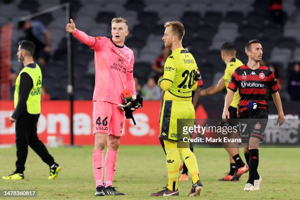 Goalkeepers Joe Gauci of Adelaide United talks to Lawrence Thomas of the Wanderers after bottles were thrown at him during the round 22 A-League...