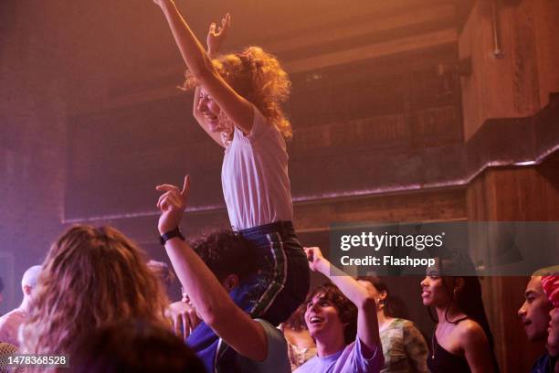 group of people having fun at a music venue. - popular music concert stock pictures, royalty-free photos & images