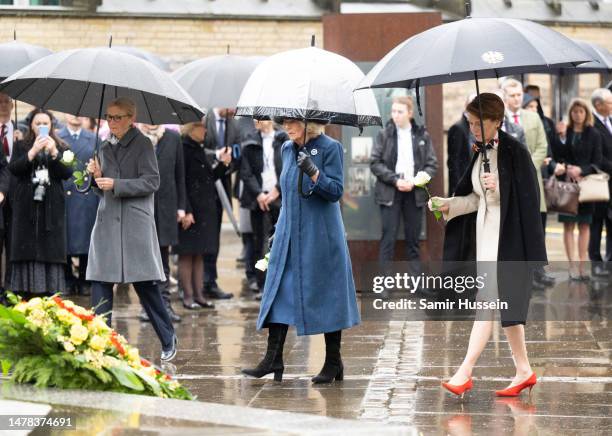 First Lady Elke Buedenbender, Camilla, Queen Consort and Eva-Maria Tschentscher place wreaths on the steps of St. Nikolai Memorial Church on March...