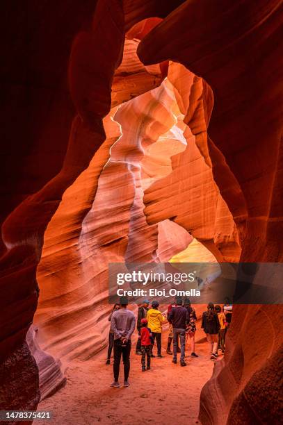 group of tourists visiting the lower antelope slot canyon. page - lower antelope stock pictures, royalty-free photos & images