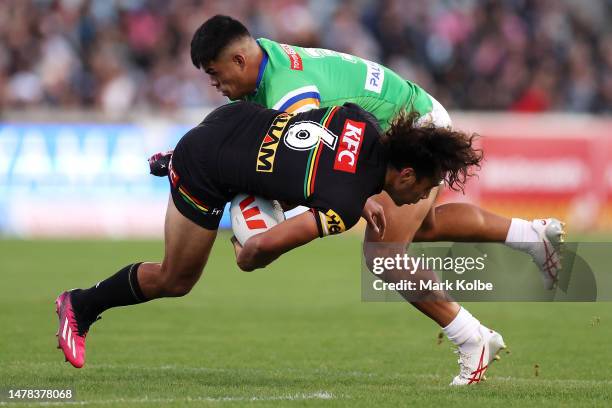 Jarome Luai of the Panthers is tackled by Matthew Timoko of the Raiders during the round five NRL match between Canberra Raiders and Parramatta Eels...