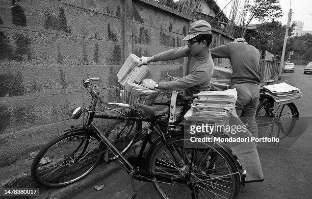 Two of the 65 thousand messengers that every day distribute to subscribers 10 million copies of national qutidiano Asahi Shimbun. Tokyo 1970 SPECIAL...