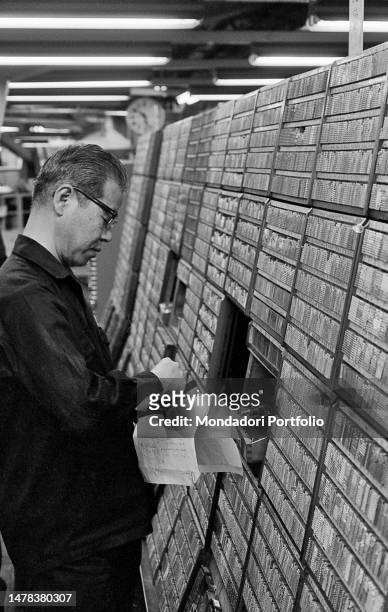 Typographer of the national newspaper Asahi Shimbun composes an article taking the ideograms from a shelf. Tokyo , March 29th, 1970 SPECIAL FEE -...