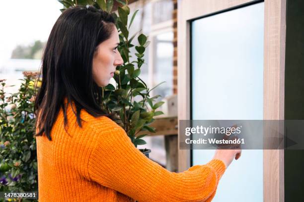 woman touching screen in nursery - interattività foto e immagini stock