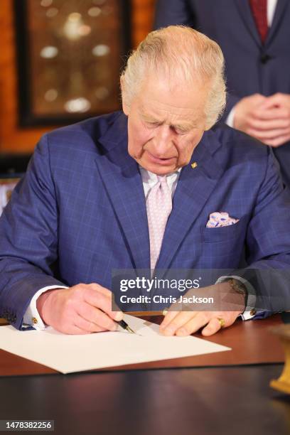 King Charles III signs Hamburg's Golden Book at Hamburg City Hall on March 31, 2023 in Hamburg, Germany. The King and The Queen Consort's first state...