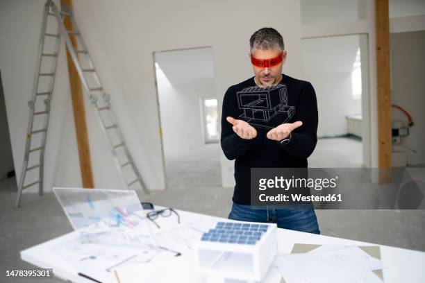mature architect wearing virtual reality simulator looking at house model - demolition site stock illustrations