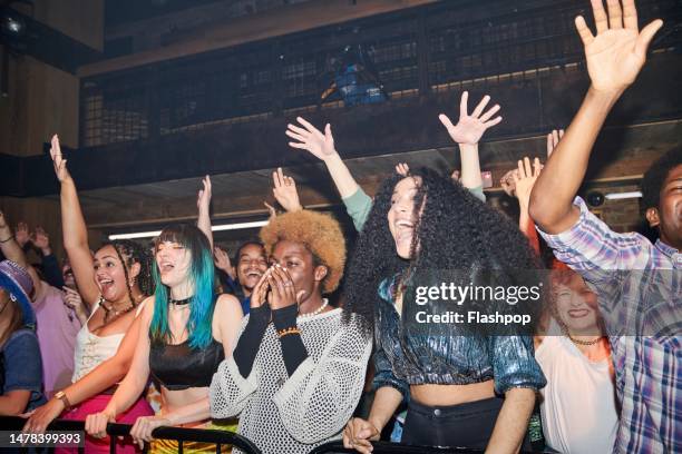 group of people having fun at a music venue. - rock music concert stock pictures, royalty-free photos & images