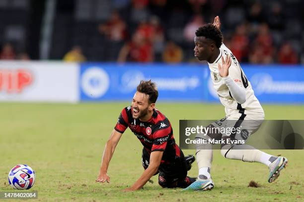 Milos Ninkovic of the Wanderers is tackled by Nestory Irankunda of Adelaide United during the round 22 A-League Men's match between Western Sydney...